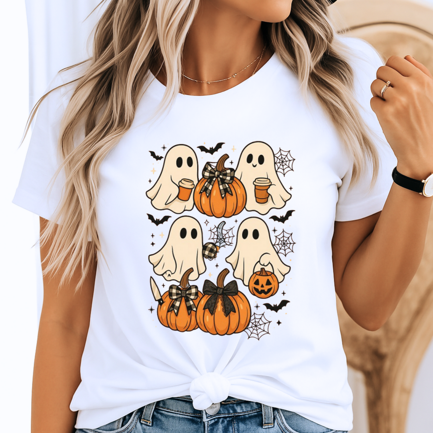 White Halloween T-shirt with cute ghost and pumpkin design. Perfect spooky season tee for women, styled with a knot tie for a trendy fall outfit. Ideal for pumpkin patch trips or Halloween celebrations.