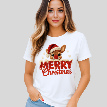 White T-shirt with faux crochet Merry Christmas reindeer design worn by woman posing in front of gray background