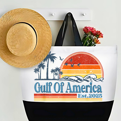 White and black tote bag with patriotic print  retro sunset design and palm trees, styled on wall hook with sun hat and flowers