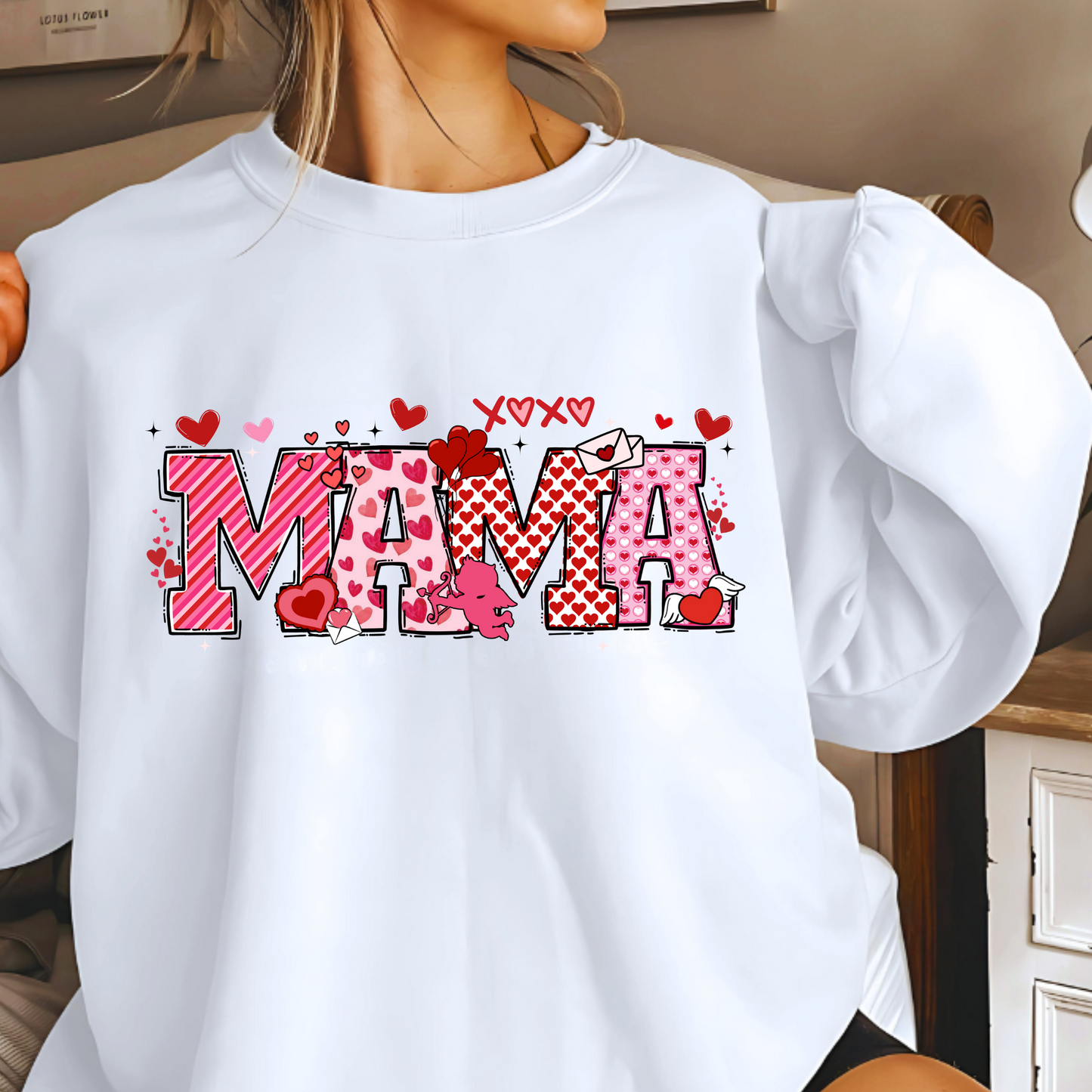 A White sweatshirt with a personalized Valentine's Day design, including the name 'MAMA' in a decorative font, surrounded by heart shapes and small decorative elements.
