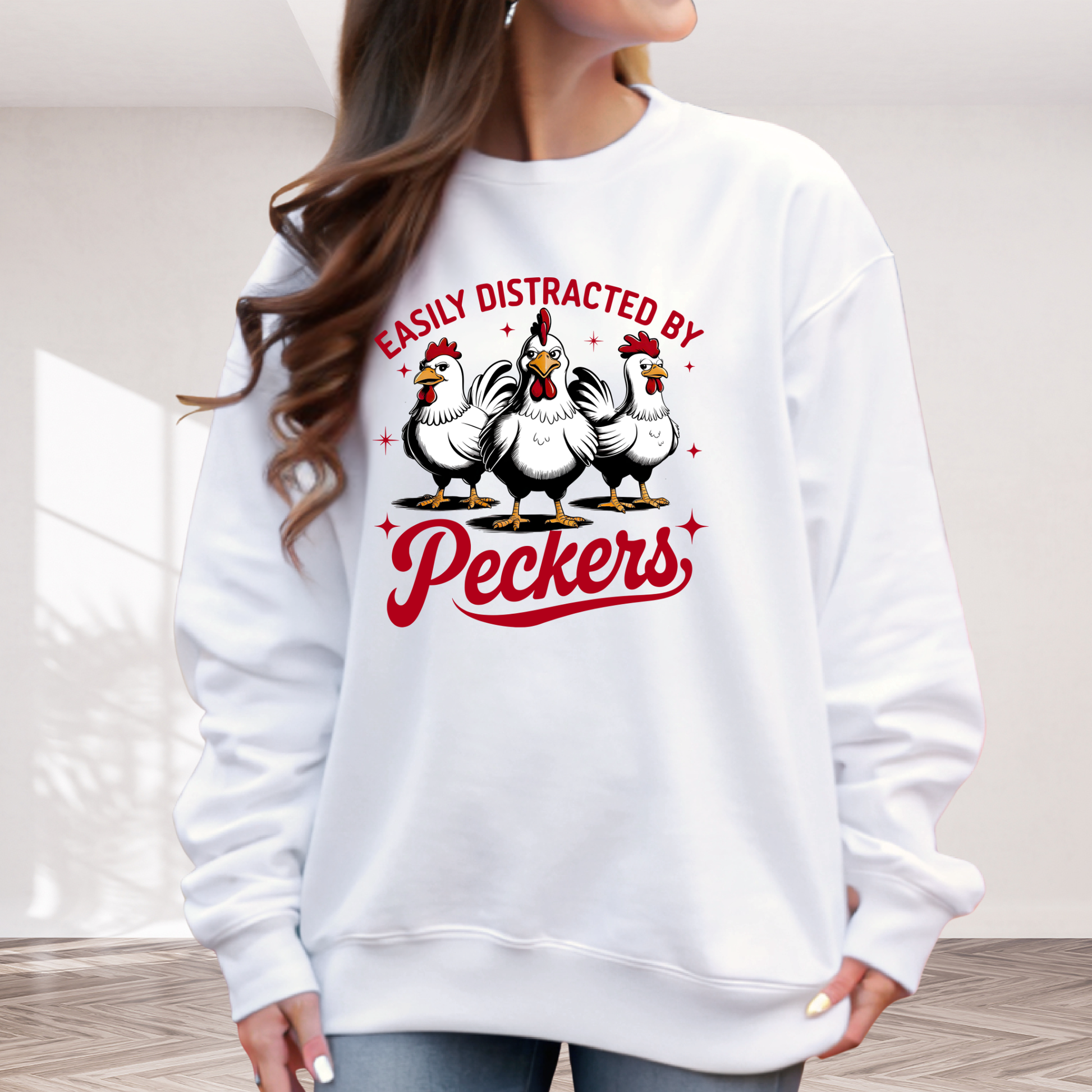 White sweatshirt with chicken graphic and text 'Easily Distracted by Peckers' worn by a woman.