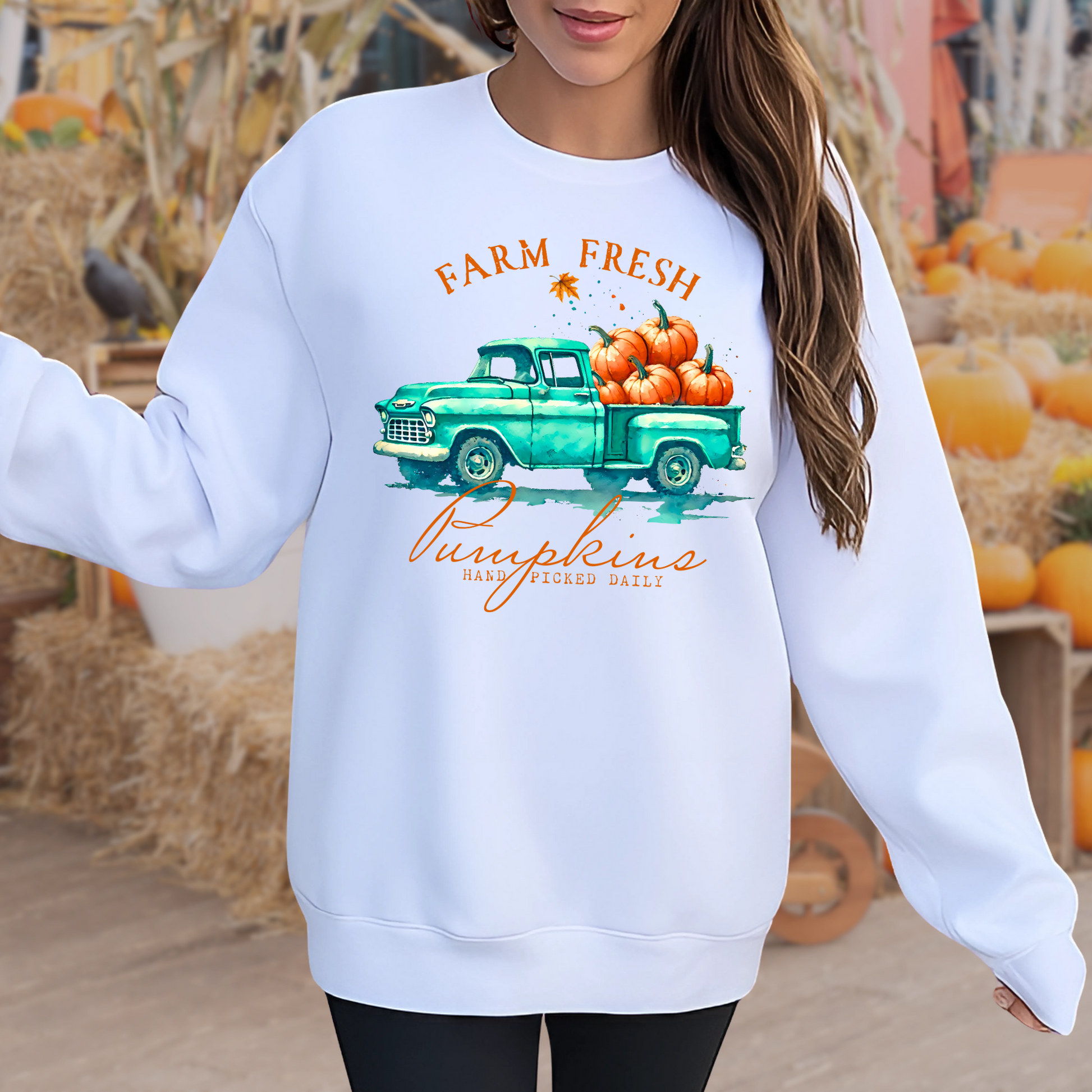 White sweatshirt with fall truck and pumpkins worn in a pumpkin patch setting
