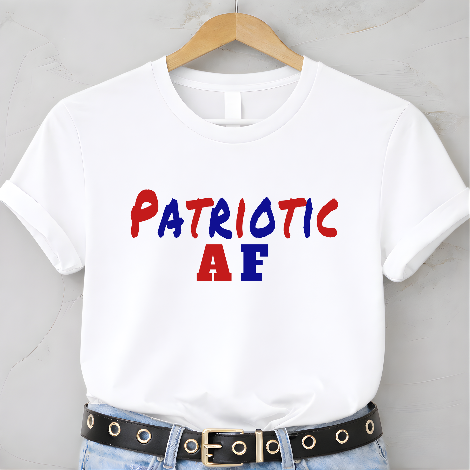 White t-shirt with 'Patriotic AF' text in red and blue on a hanger.