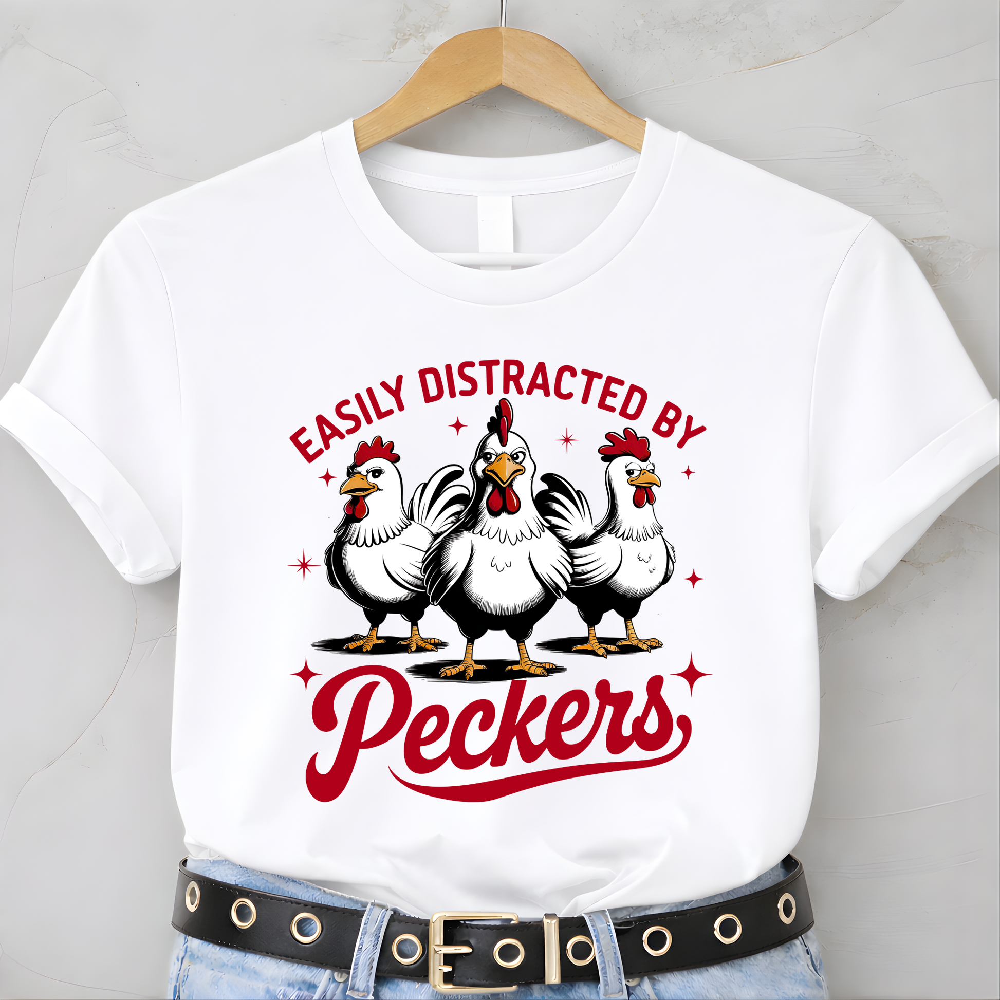 White t-shirt with chicken graphic and text 'Easily Distracted by Peckers' on a hanger.
