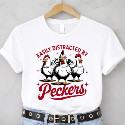 White t-shirt with chicken graphic and text 'Easily Distracted by Peckers' on a hanger.