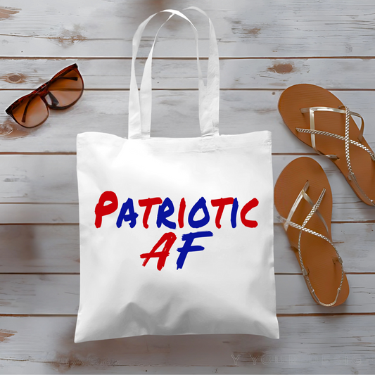 Woman holding canvas tote bag with bold red and blue 'Patriotic AF' text