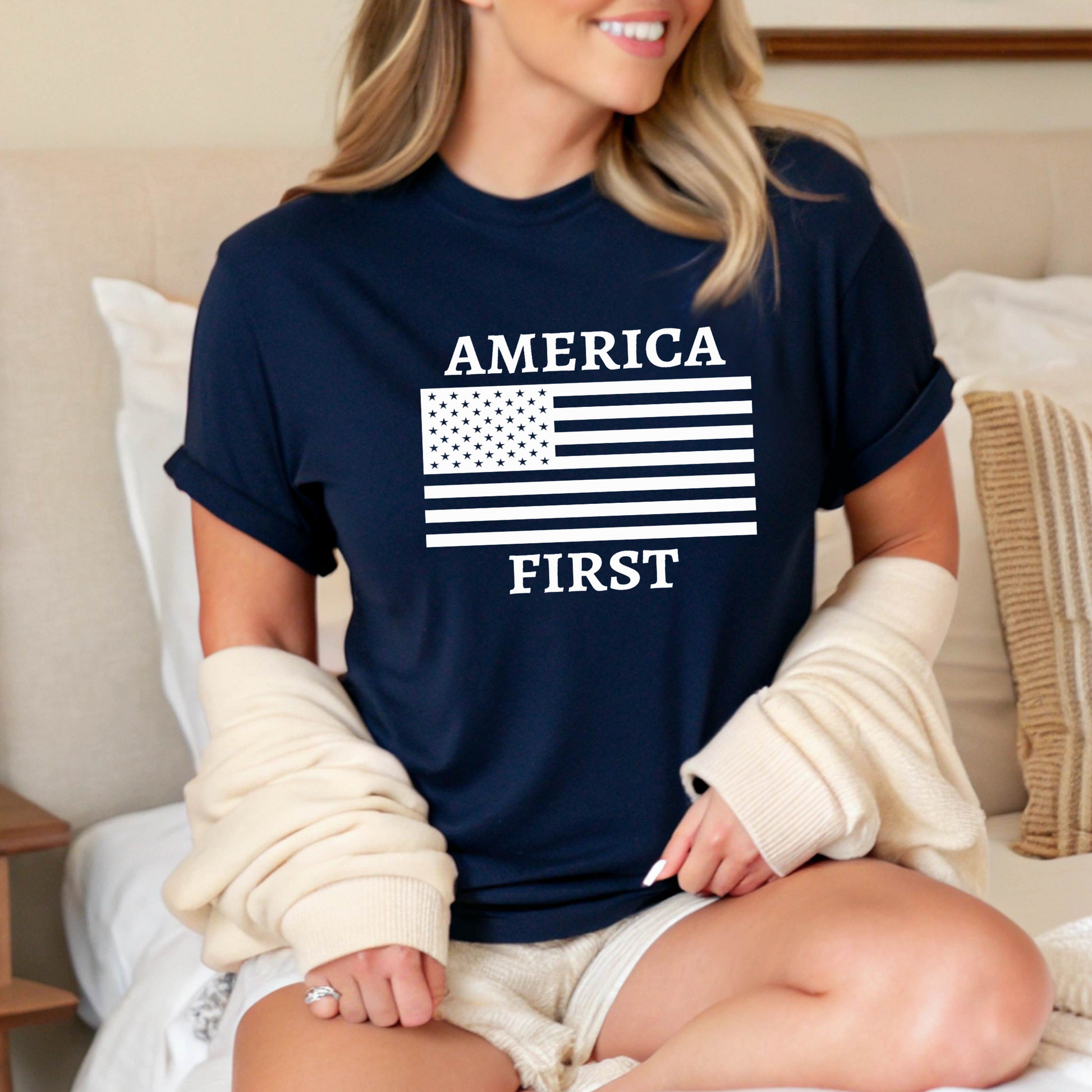 Woman in Navy tee featuring bold white “America First” patriotic graphic