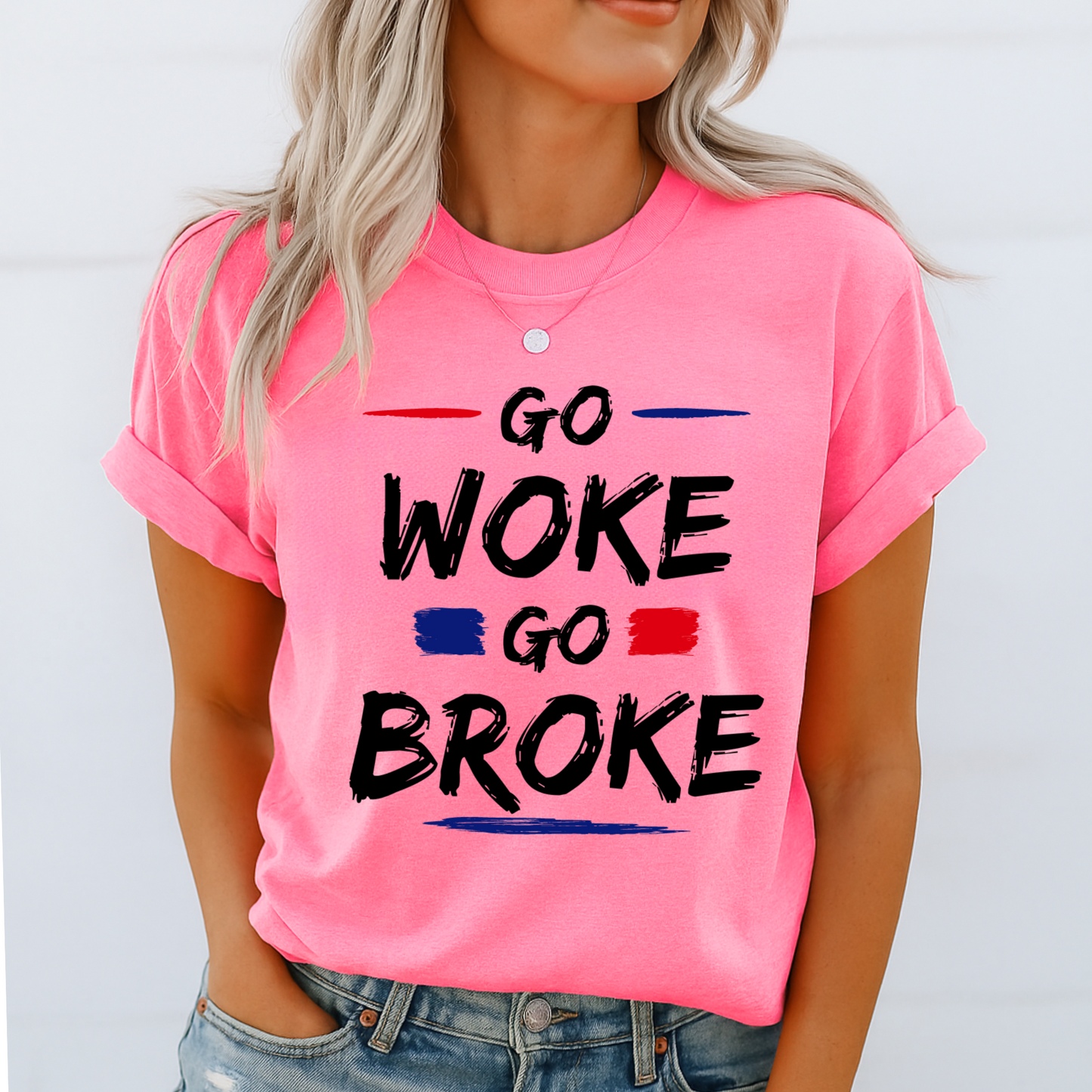 Woman in bright safety pink tee with “Go Woke Go Broke” design, styled for summer
