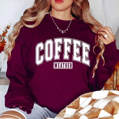 Woman in maroon crewneck with brown “Coffee Weather” text, cozy fall vibe