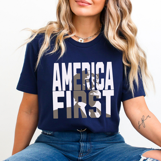 Woman in navy blue “America First” shirt, confident stance