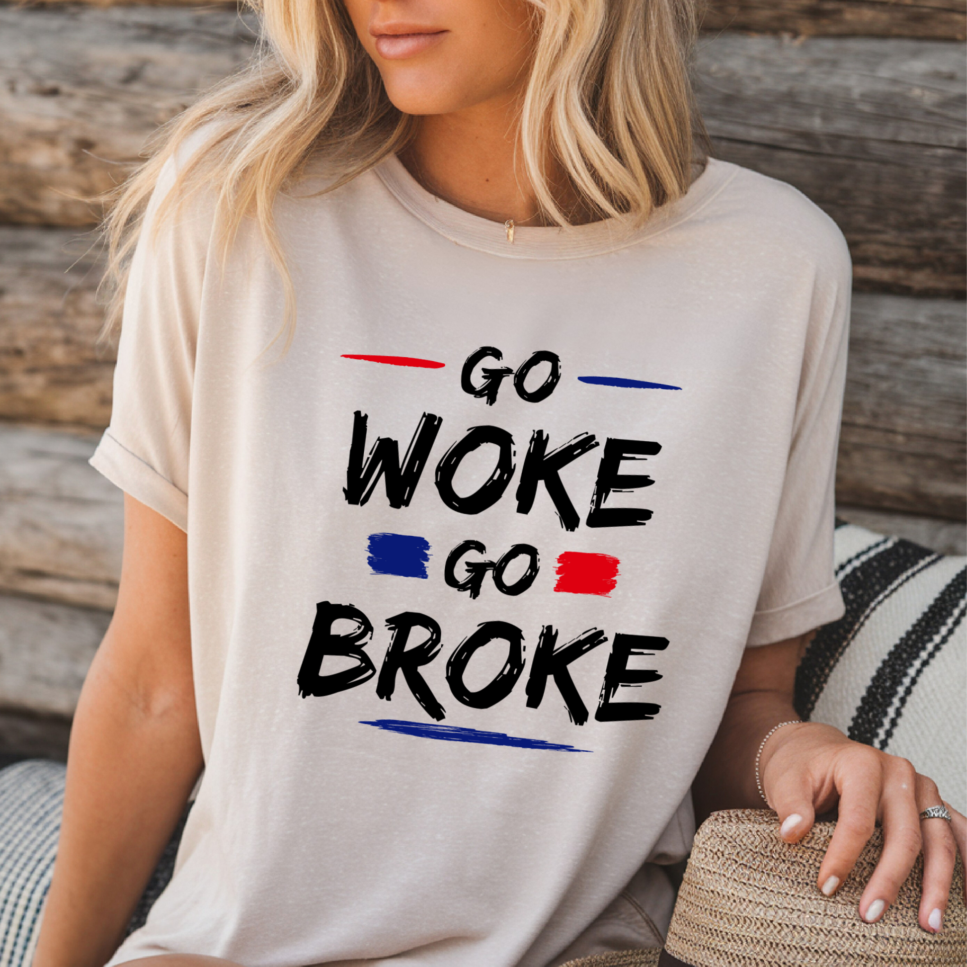 Woman in sand-colored tee featuring “Go Woke Go Broke” patriotic slogan