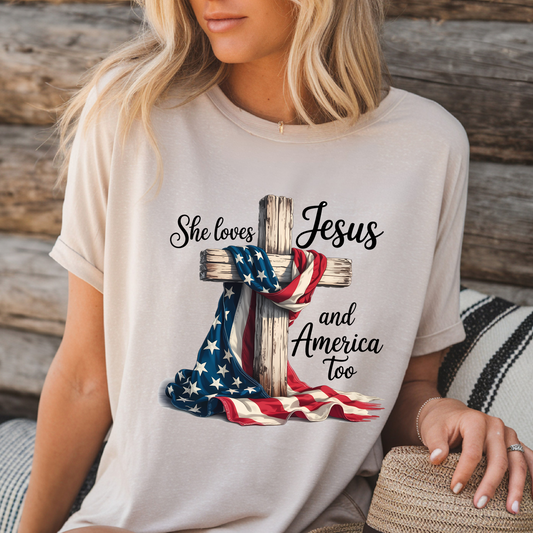 Woman in sand color “Jesus and America” shirt sitting outdoors

