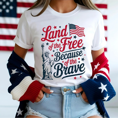 Woman in white tee with red/blue patriotic print, smiling in front of flag