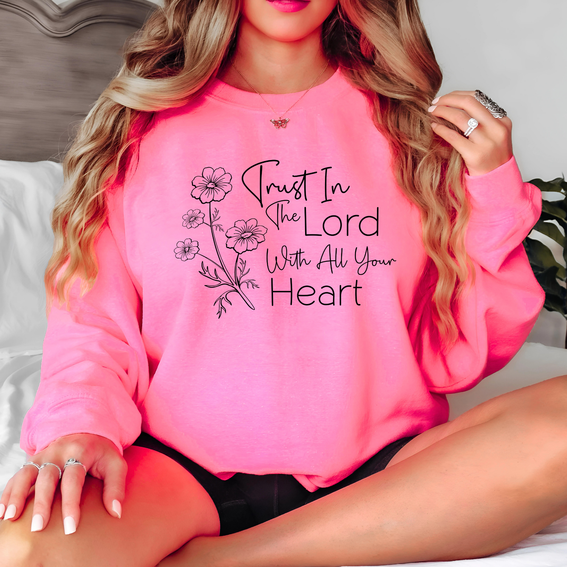 Bright pink cozy sweatshirt with scripture graphic