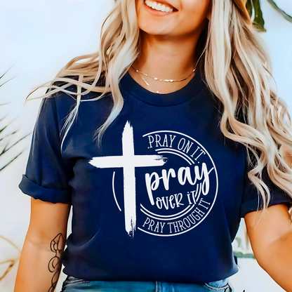 Woman wearing Navy T-shirt with black cross graphic and inspirational pray wording.