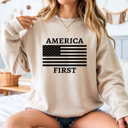 Woman wearing a beige sweatshirt with 'AMERICA FIRST' and an American flag design.