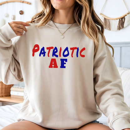 Woman wearing a beige sweatshirt with 'Patriotic AF' text in red, white, and blue.