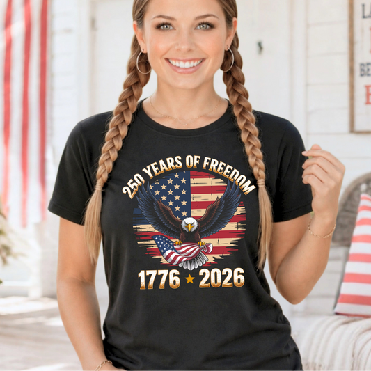Woman wearing a black t-shirt with an eagle and American flag design, celebrating 250 years of freedom.