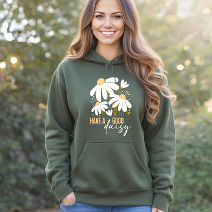 Woman wearing a green hoodie with floral design and text outdoors