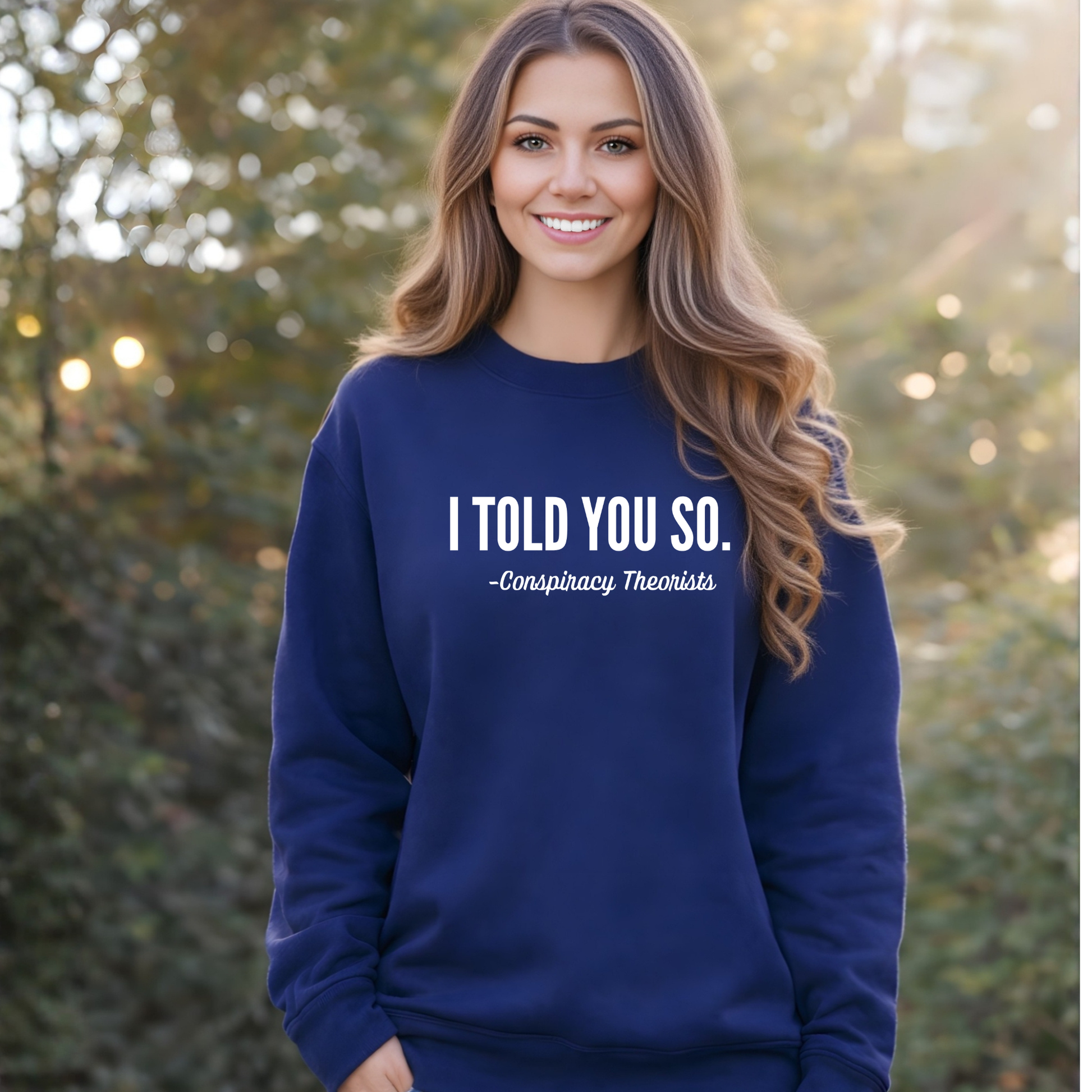 Woman wearing a navy blue sweatshirt with text, standing outdoors.