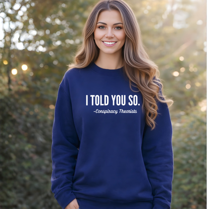 Woman wearing a navy blue sweatshirt with text, standing outdoors.