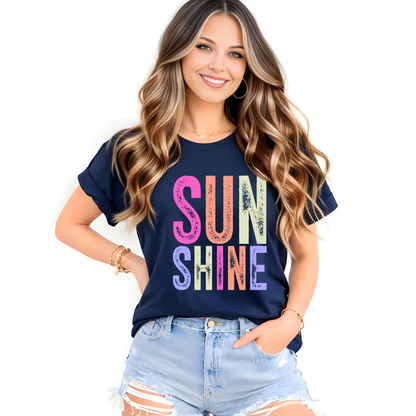 Woman wearing a navy blue t-shirt with 'SUN SHINE' in colorful letters on a white background