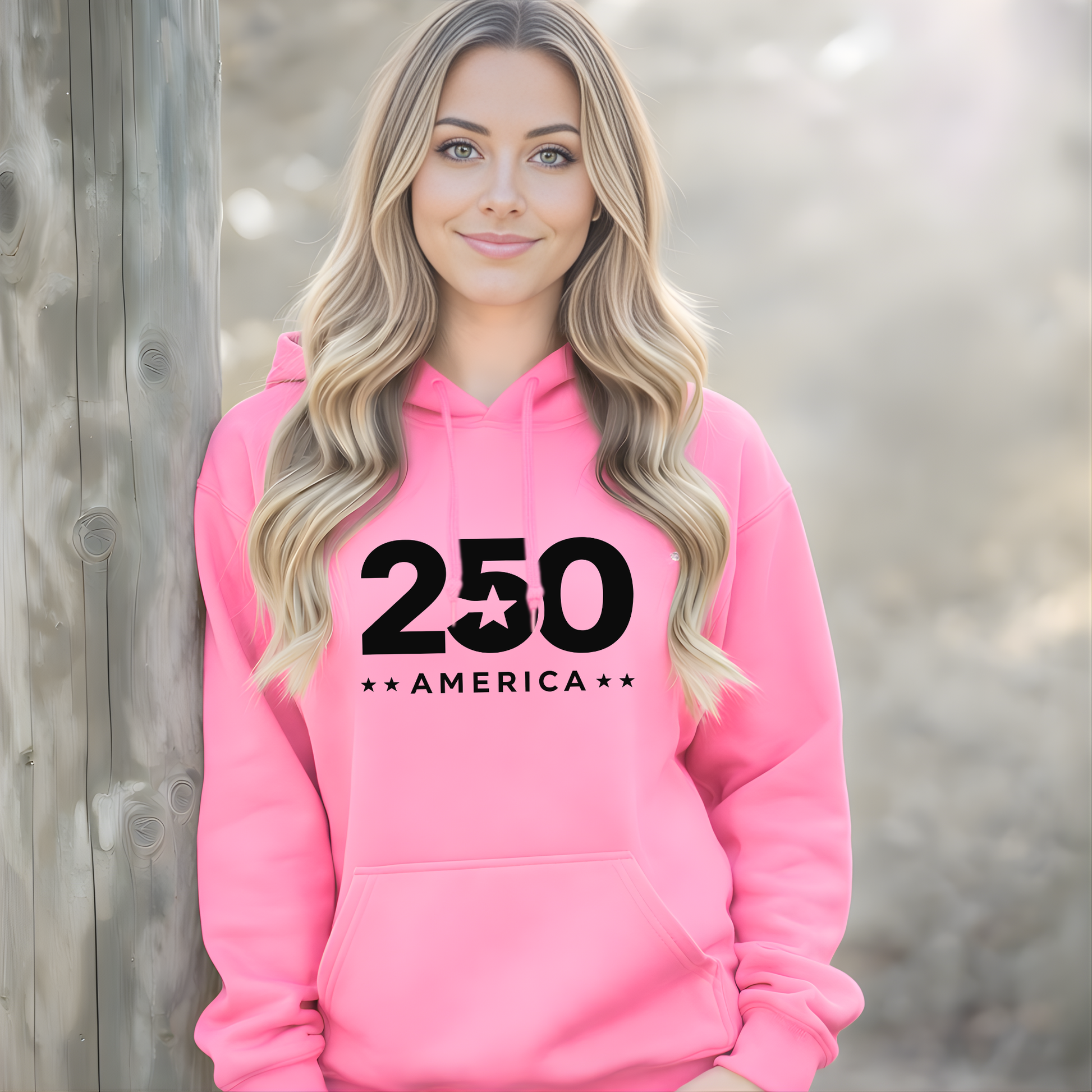 Woman wearing a pink hoodie with '250 America' text