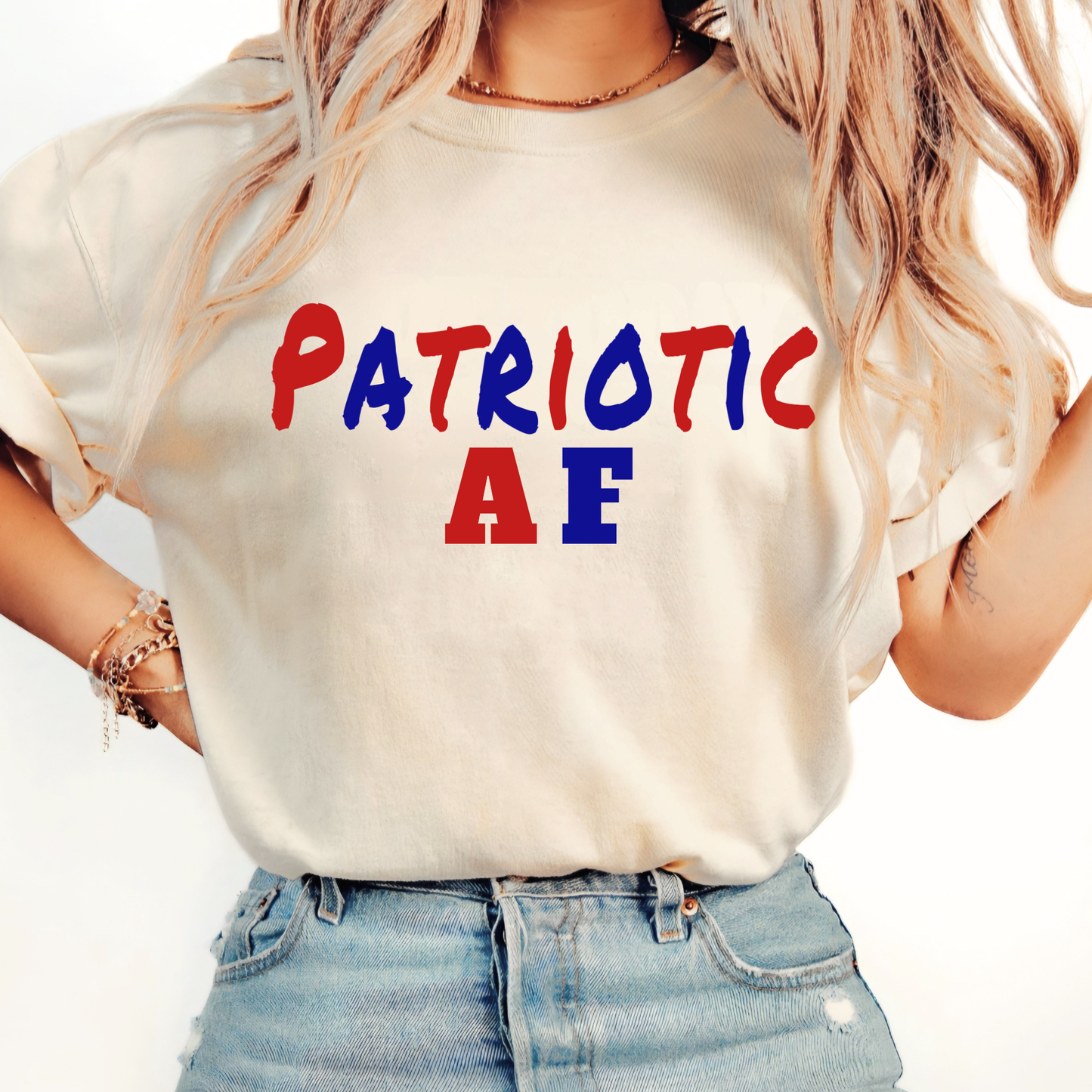 Woman wearing a white t-shirt with 'Patriotic AF' text in red, blue, and green on a plain background