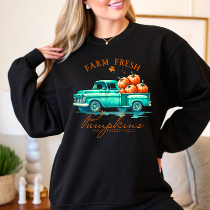Woman wearing black Farm Fresh Pumpkins sweatshirt indoors with a cozy smile

