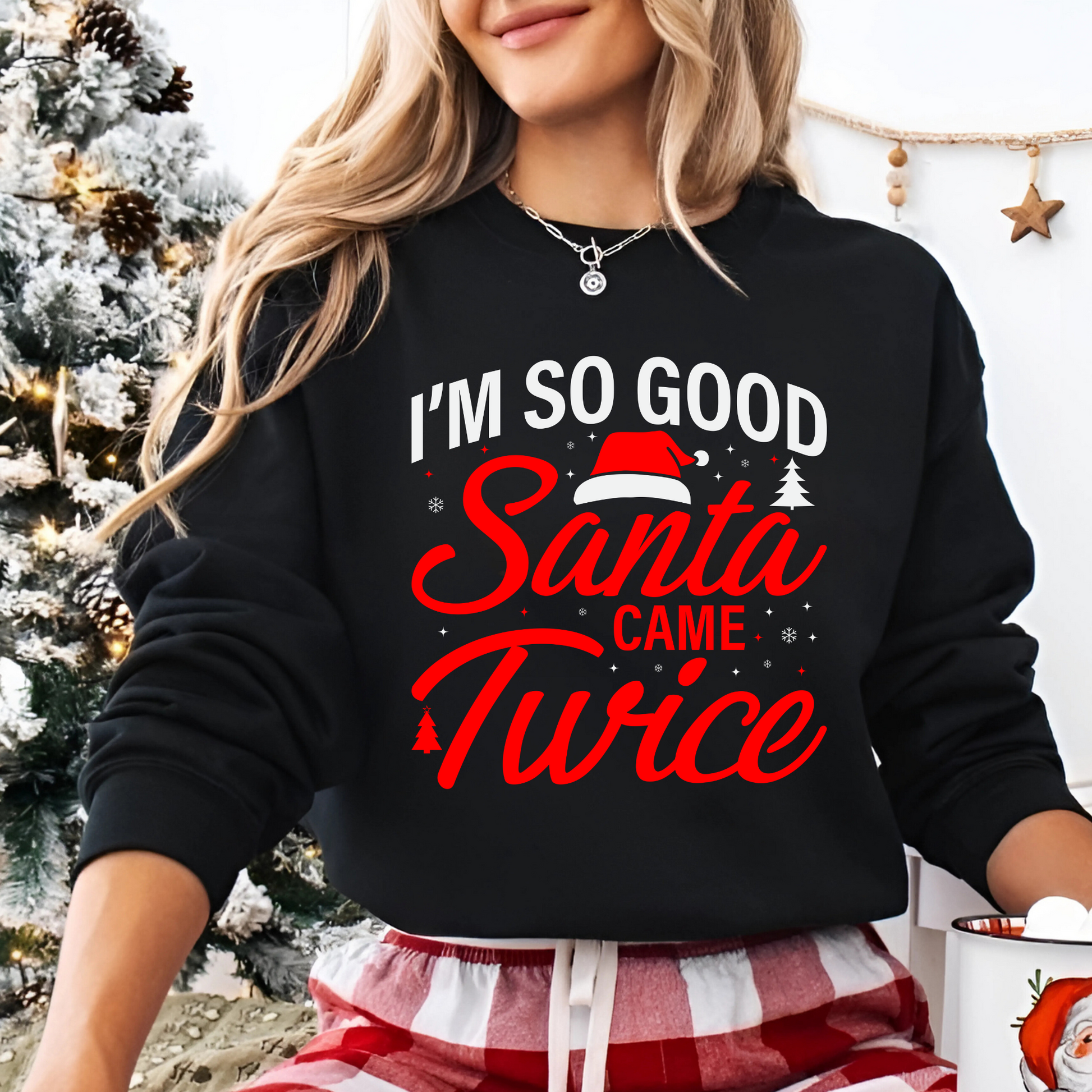 Woman wearing black “I’m So Good Santa Came Twice” Christmas sweatshirt

