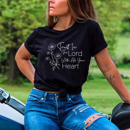 Woman wearing black T-shirt with floral graphic and “Trust in the Lord With All Your Heart” text.