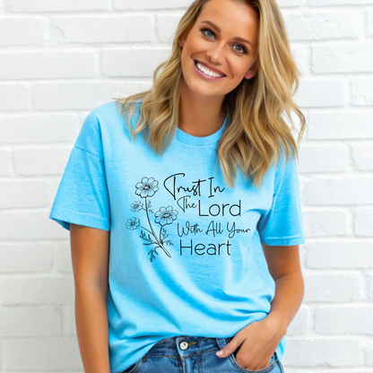 Woman wearing Blue T-shirt with floral graphic and “Trust in the Lord With All Your Heart” text.