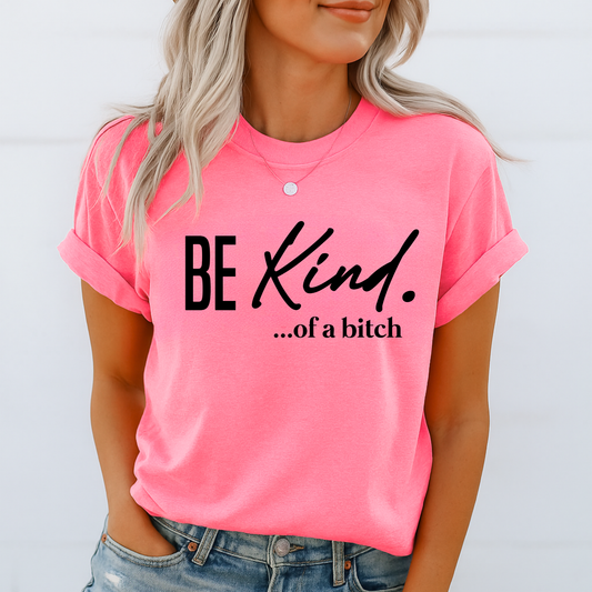 Woman wearing bright pink shirt with bold sarcastic “Be Kind…of a bitch” text

