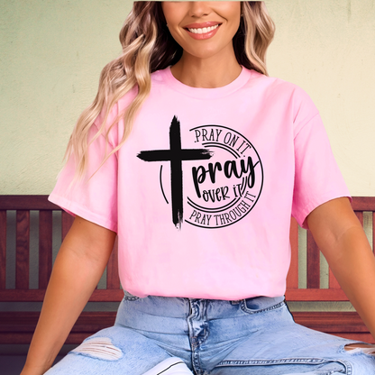 Woman wearing light Pink T-shirt with black cross graphic and inspirational pray wording.
