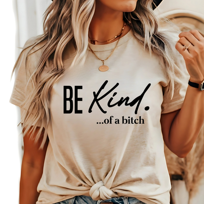 Woman wearing natural beige shirt with “Be Kind…of a bitch” design in black fontt