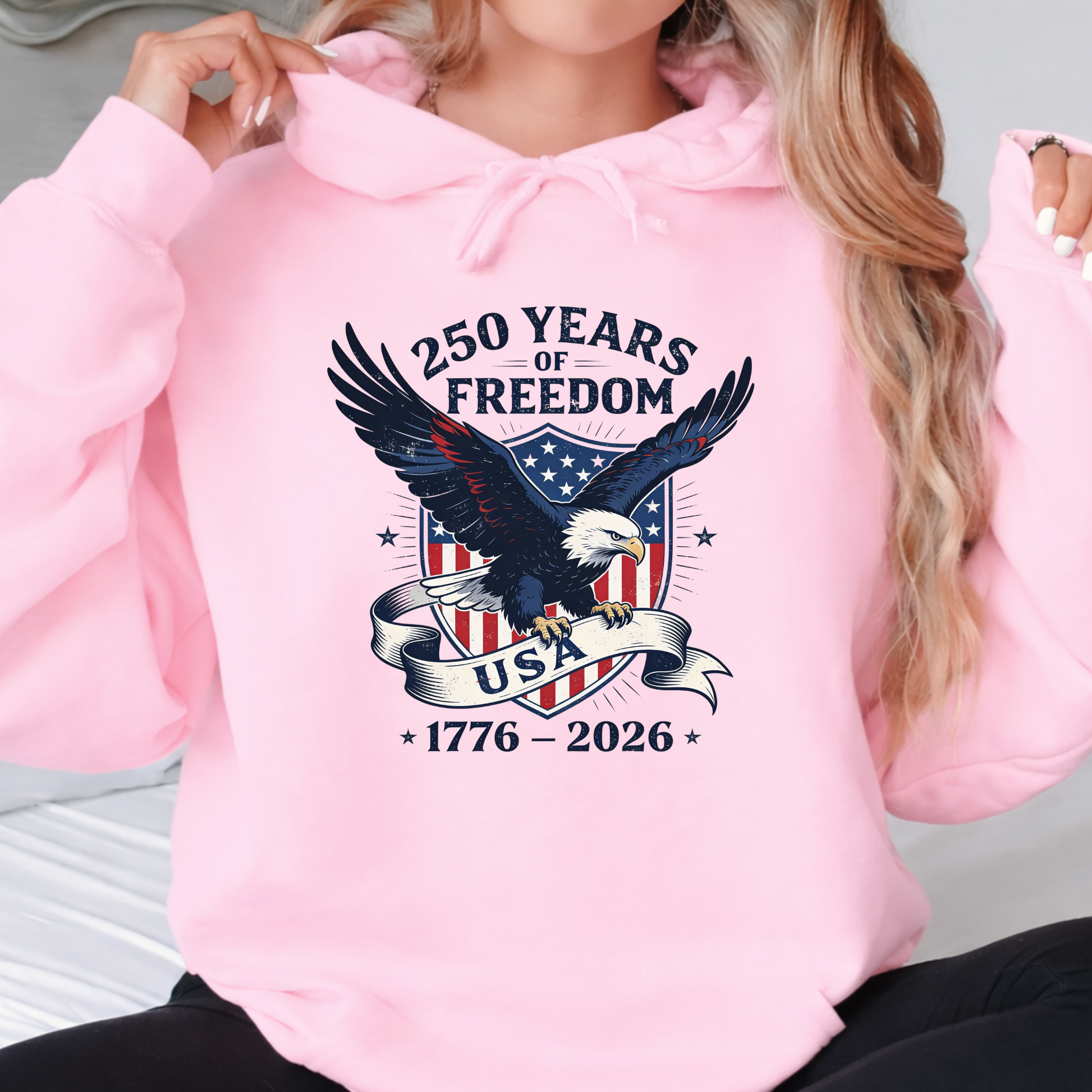 Woman wearing pink America 250 hoodie eagle patriotic design front view