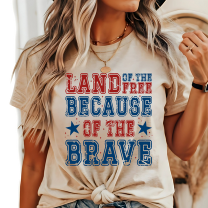 Woman wearing sand-colored tee with bold patriotic lettering and the Statue of Liberty

