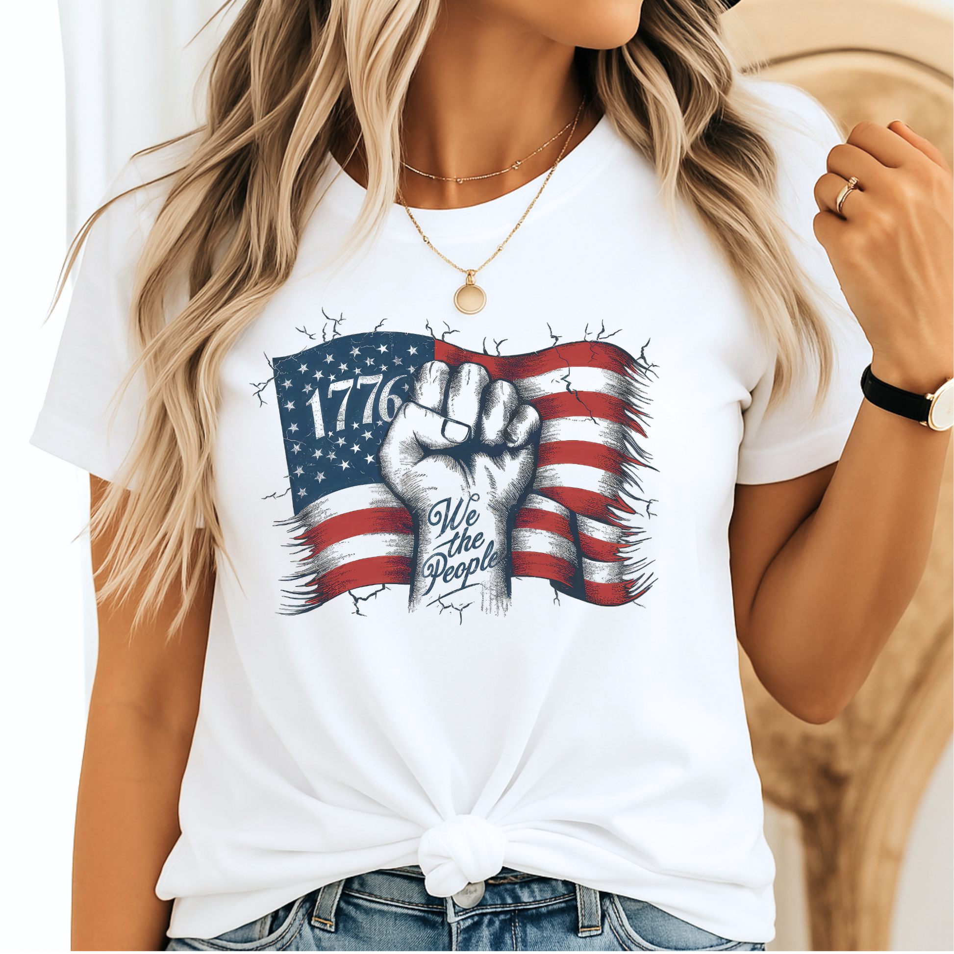 Woman wearing white 1776 We The People shirt with blue jeans, smiling – front view.


