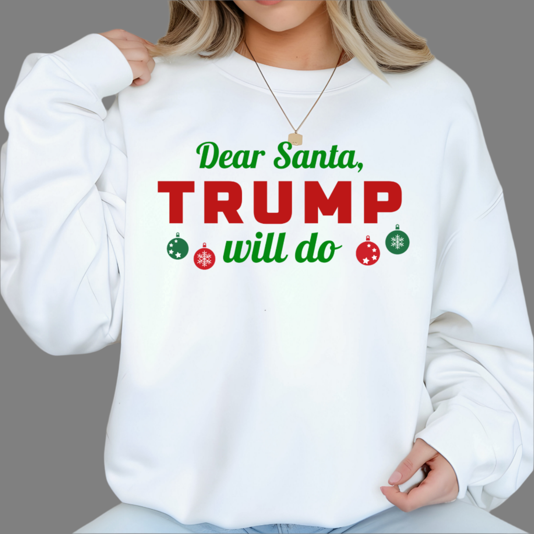 Woman wearing white “Dear Santa, Trump Will Do” Christmas sweatshirt with red and green lettering