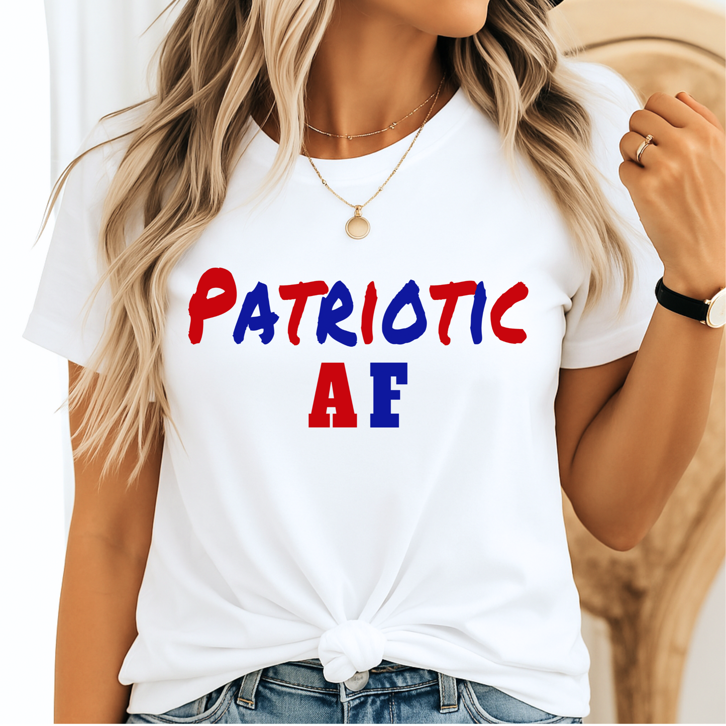 Woman wearing white “Patriotic AF” tee with red and blue lettering, styled with a knot