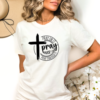Woman wearing White T-shirt with black cross graphic and inspirational pray wording.