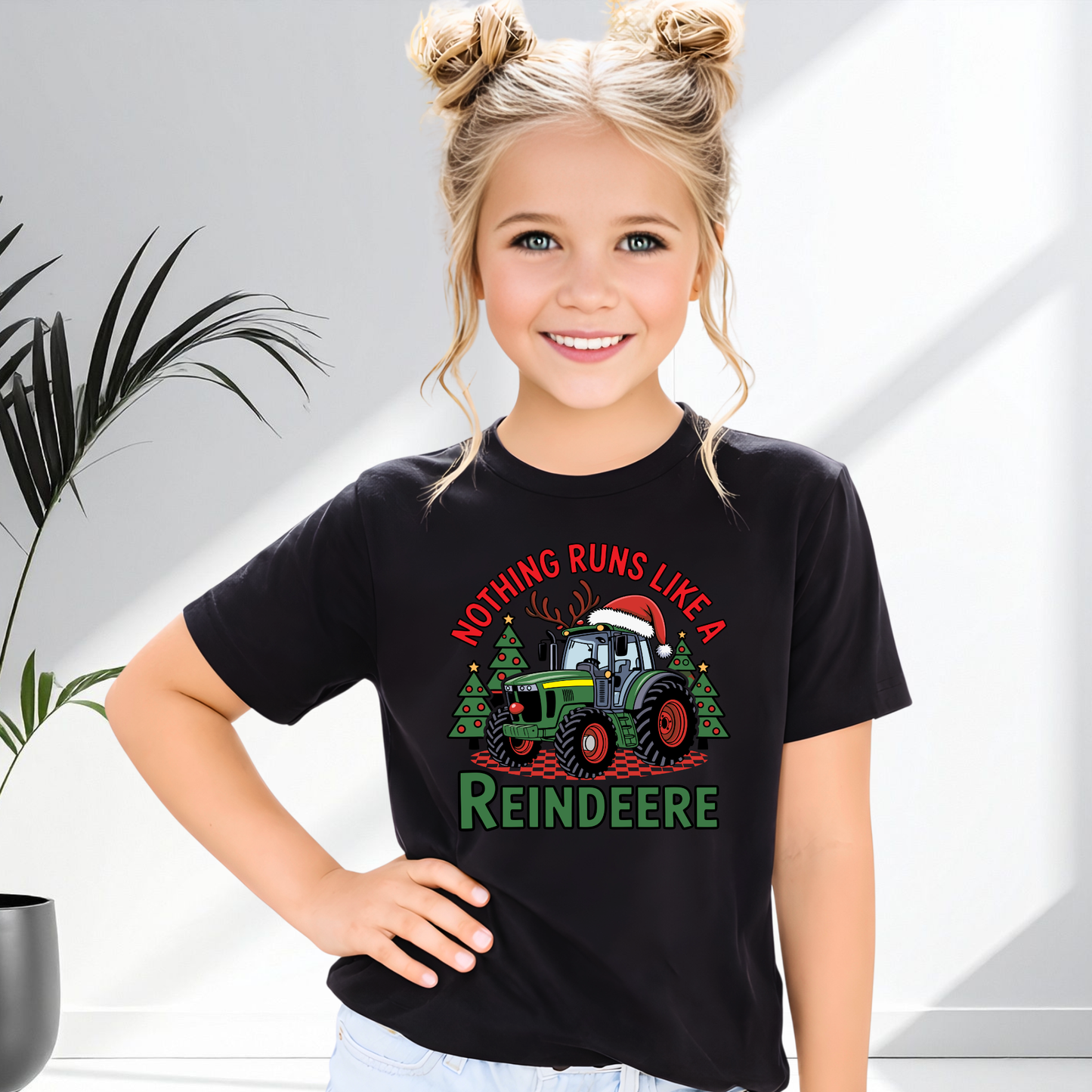 Young girl wearing a black t-shirt with a Farm Christmas-themed design featuring a reindeer and tractor.