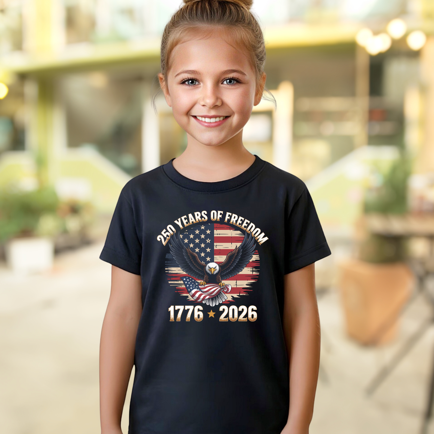 Young girl wearing a black t-shirt with a design celebrating 250 years of freedom, standing outdoors.