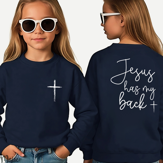 Young girl wearing a navy blue 'Jesus Has My Back' youth sweatshirt with a cross design