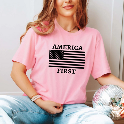 Young woman in light pink patriotic shirt with “America First” text and flag