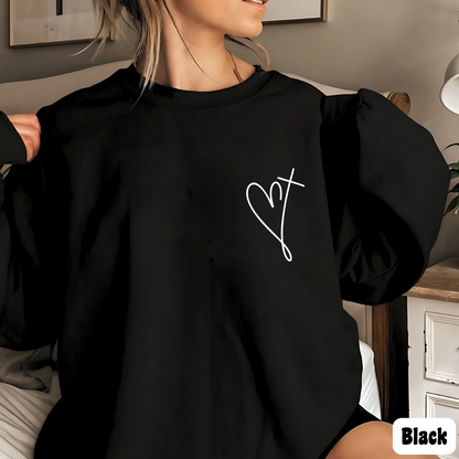 Woman wearing a black sweatshirt with minimalist heart and cross chest design, Valentine's Day outfit