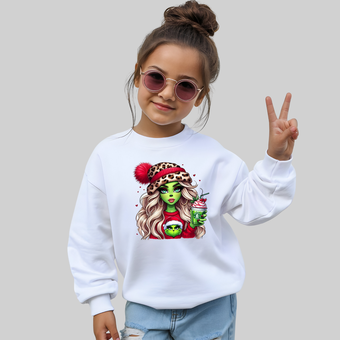 Child wearing a white sweatshirt with a colorful graphic design on a plain background