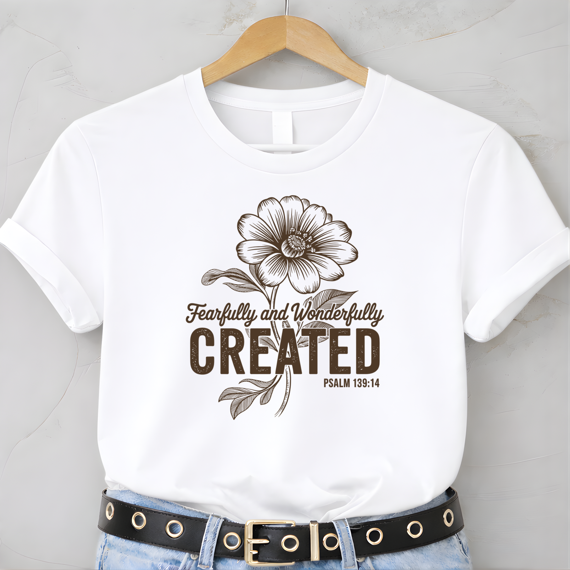 White youth t-shirt with Fearfully and Wonderfully Created floral design on hanger