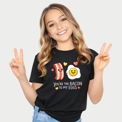 youth girl wearing black valentine t shirt with you’re the bacon to my eggs design