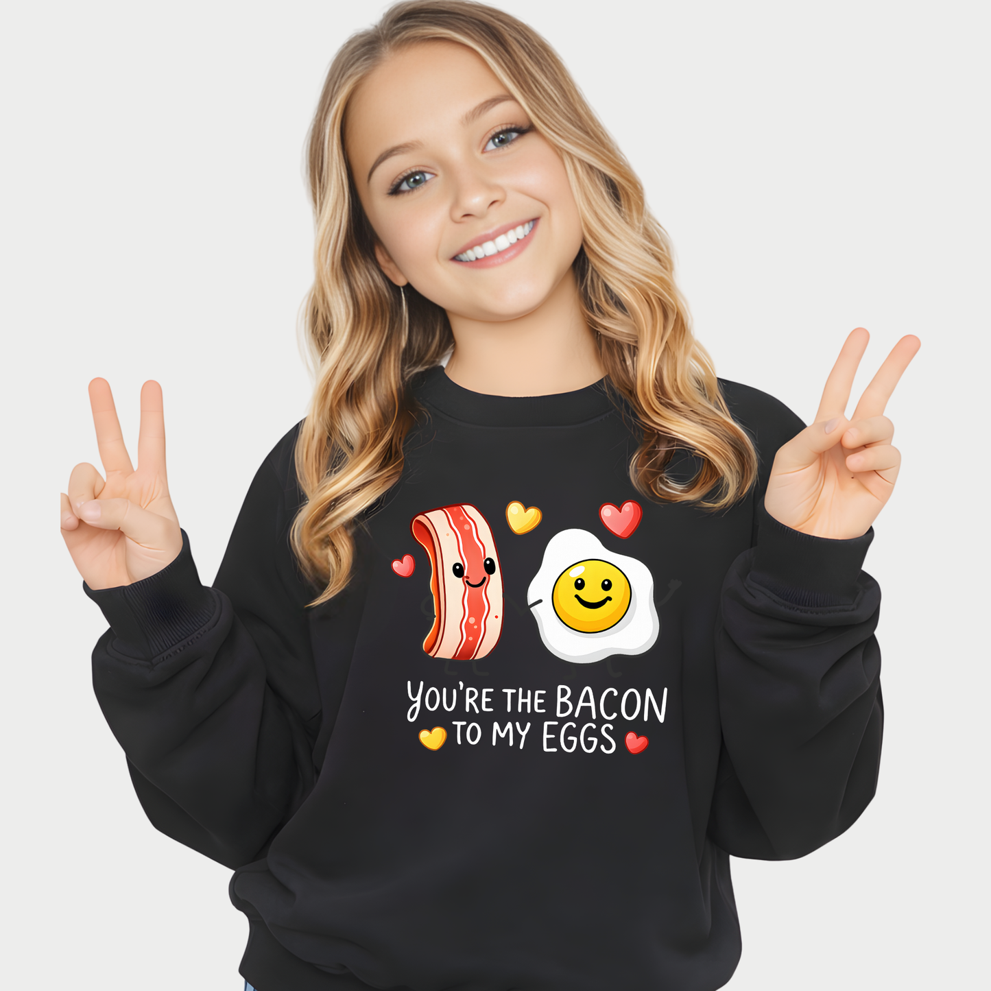 youth girl wearing black valentine sweatshirt with bacon and egg you’re the bacon to my eggs graphic